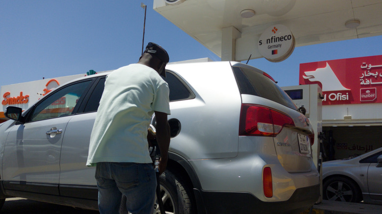 Man in Libya filling up with gas