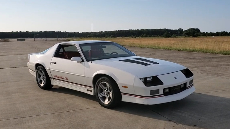 Front 3/4 of 1990 Chevrolet Camaro IROC-Z in white with black details