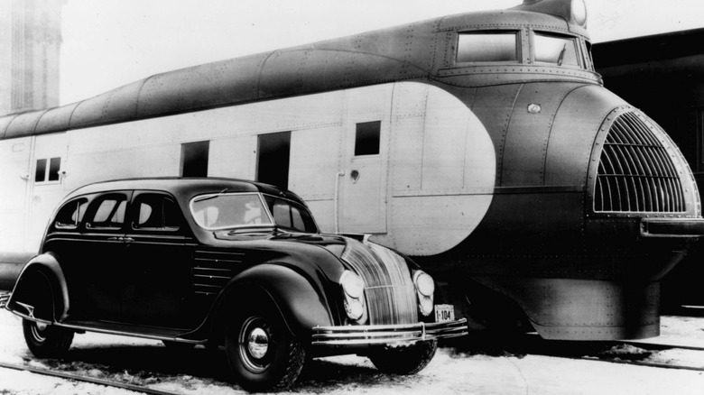 Vintage photo of 1934 Chrysler Airflow parked next to the streamlined Union Pacific M-10000.