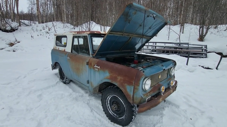 Unrestored 1961 International Harvester Scout parked in snow