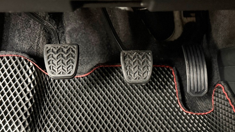 Showing all three pedals associated with a manual-transmission car.