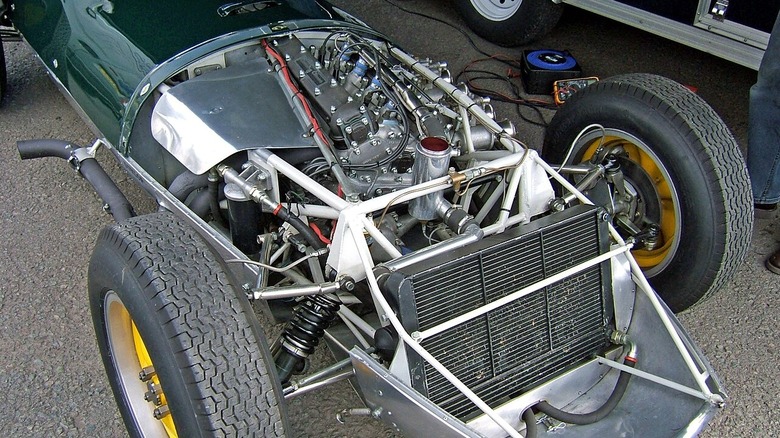 A Lotus 16 Formula One car with the hood removed to show its Coventry Climax FPF straight-4 engine.