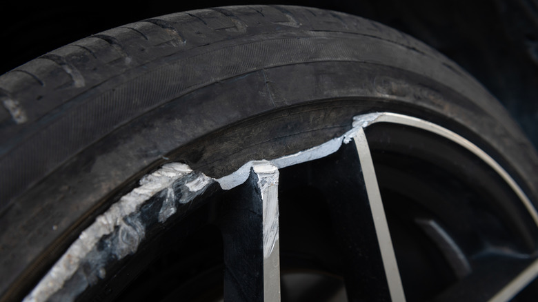 A damaged rim with a tire attached
