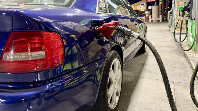 Pumping 100 octane race gasoline into a B5-generation Audi S4 at night.