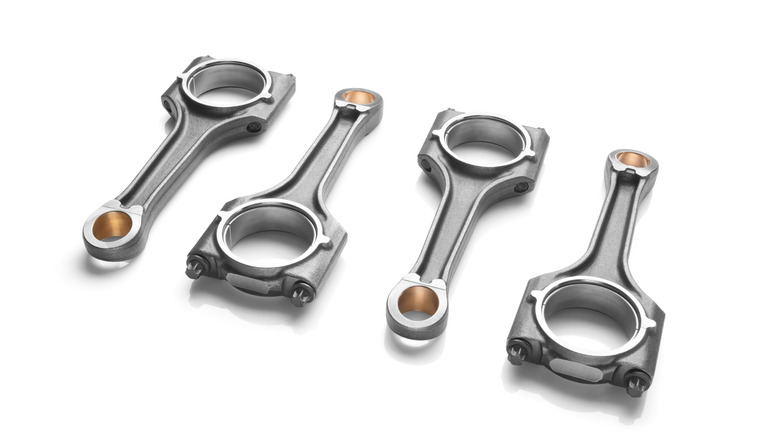 A set of connecting engine rods on white background.