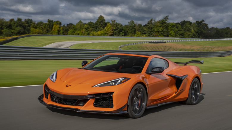 A 2023 Chevrolet Corvette Z06 in Amplify Orange Tint driving on a track.