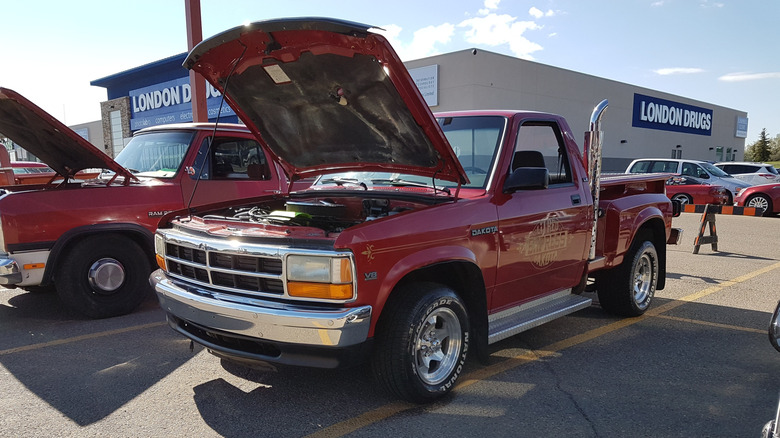 Front-quarter shot of a Dodge Dakota L'il Red Express truck parked with its hood open at a car meet
