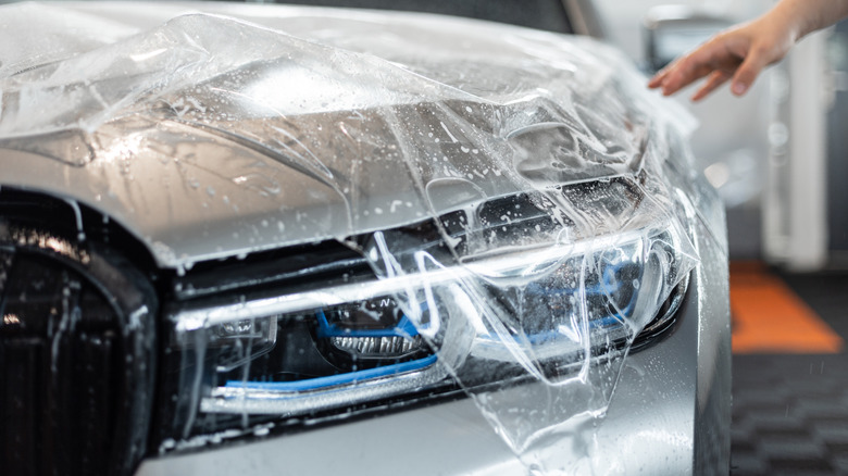 Car on detailing service. Protection of car hood with PPF film