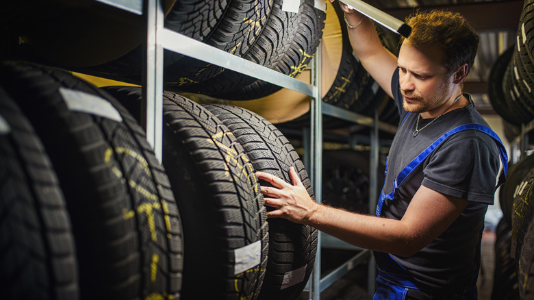 A tire technician checking tire condition