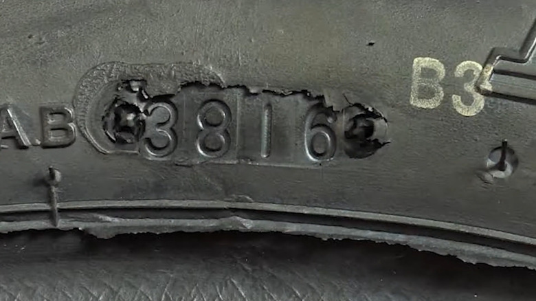 A tire identification number that's been tampered with