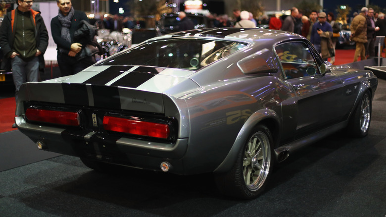 A rear view of an Eleanor Mustang parked at an indoor car show