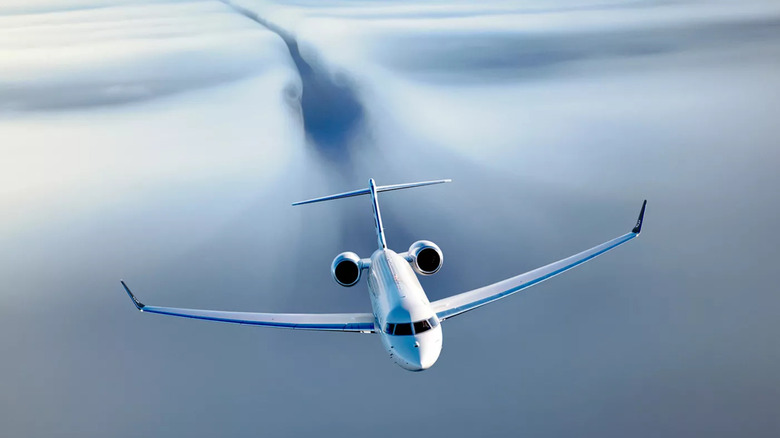 Image of Bombardier Global 8000 flying above the clouds