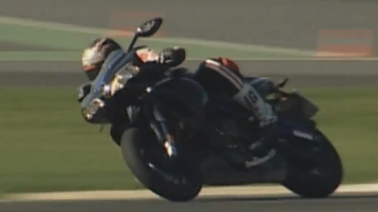 A rider leans a Buell 1125R into a corner on a track.