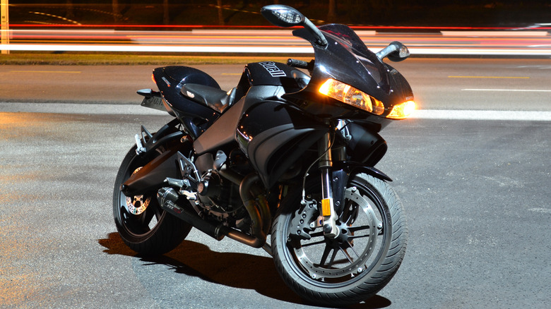 A nighttime picture of a black 2009 Buell 1125R.