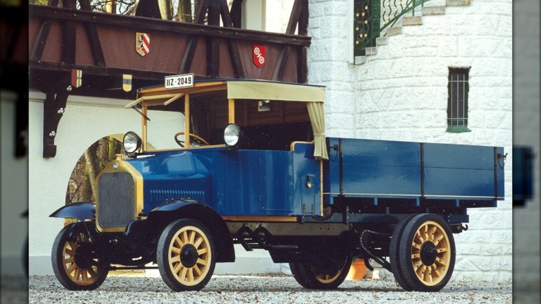 A 1924 MAN diesel truck with a blue body and gold trim.