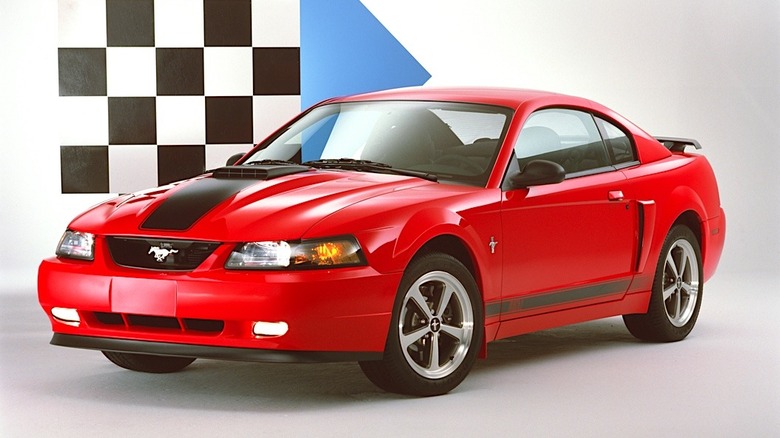 A new edge 2003 Ford Mustang Mach 1 in red sitting in-studio.