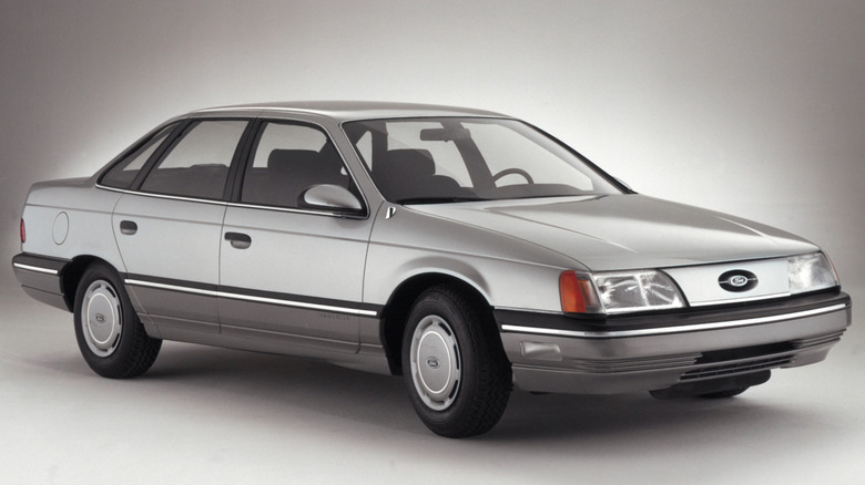 A front 3/4 shot of a gray1986 Ford Taurus in a studio