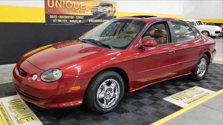 A 2,900-mile perfectly preserved red 1996 Ford Taurus SHO with the 3.4-liter Yamaha 60-degree V8