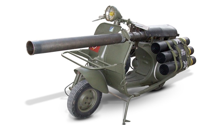 A green Vespa 150 TAP on a white background.