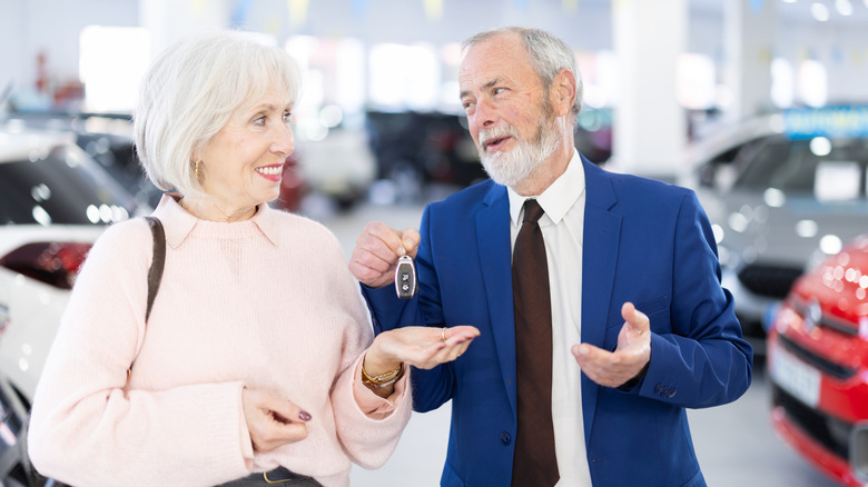 older salesperson talking to an elderly customer