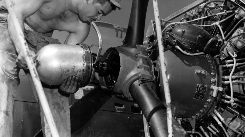 A personnel of nan subject moving connected a B-29 motor during nan Korean War
