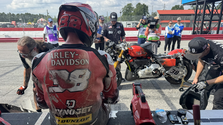 Bradley Smith waiting for his bike to be repaired