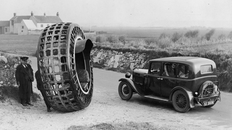 A dynasphere next to a car on the road