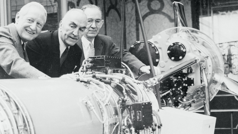 Three executives study an Allison turbo jet engine at a New York press conference. From left: Harlow H. Curtice, president of General Motors; Capt. Eddie Rickenbacker, Easten Airlines chairman; and Edward B. Newill, GM vice president and general manager of its Allison Division.