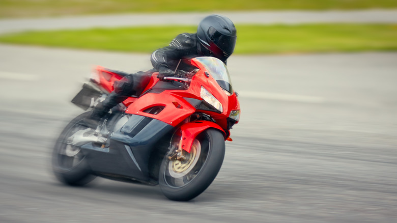 A rider on a sport bike driving on track.