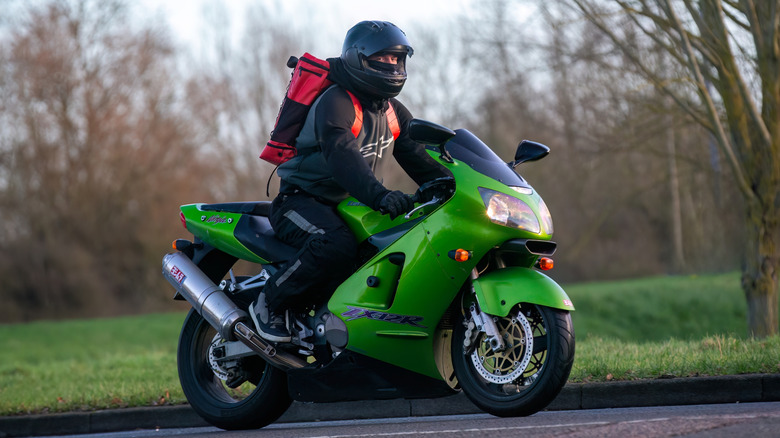 A green Kawasaki ZX-12R driving on a public road.