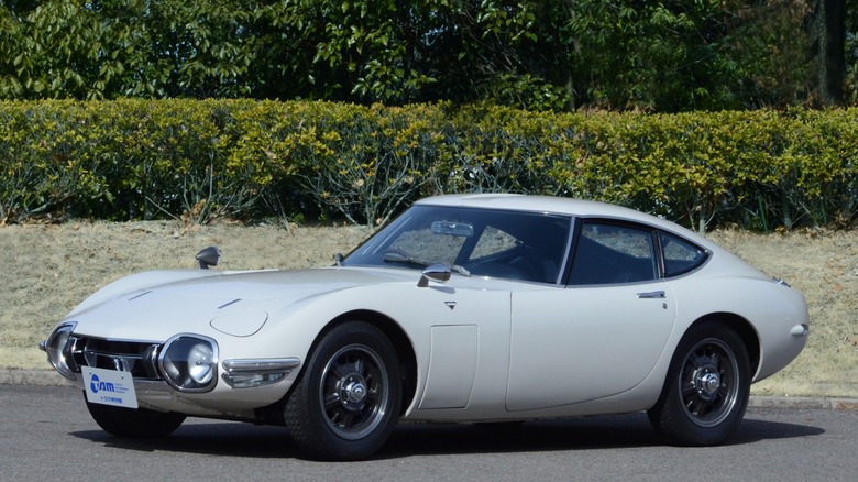 A classic gray 1967 Toyota 2000GT coupe parked outdoors, front three-quarter view