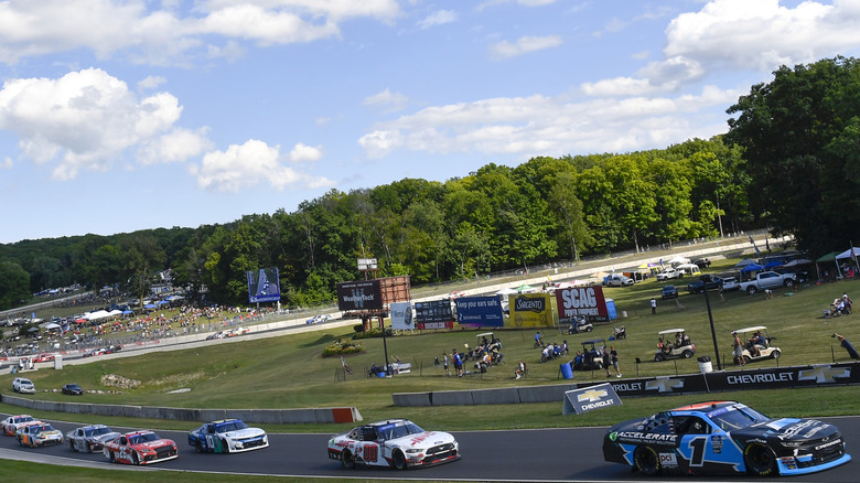 Cars racing down the track at Road America