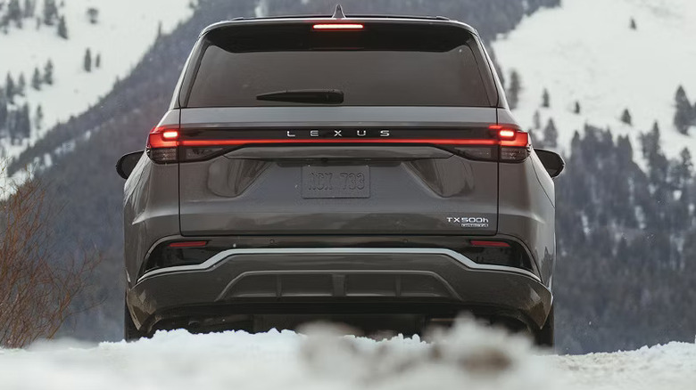 A geay Lexus TX500h driving in the snow