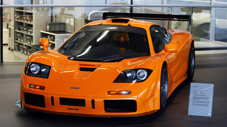 An orange McLaren F1 LM parked indoors on display.