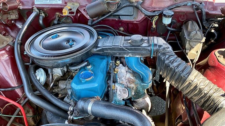 The engine bay in a 1982 AMC Spirit liftback base model with the GM-sourced 151-cubic-inch (2.5-liter) "Iron Duke" straight four-cylinder.
