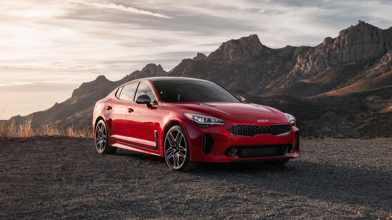 Dramatic front 3/4 of 2022 Kia Stinger in front of rocky mountains