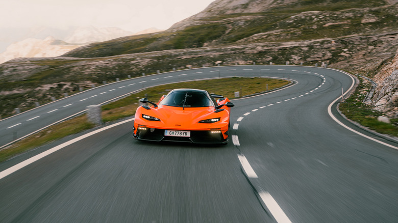 An orange KTM X-Bow GT-XR driving on a mountain road