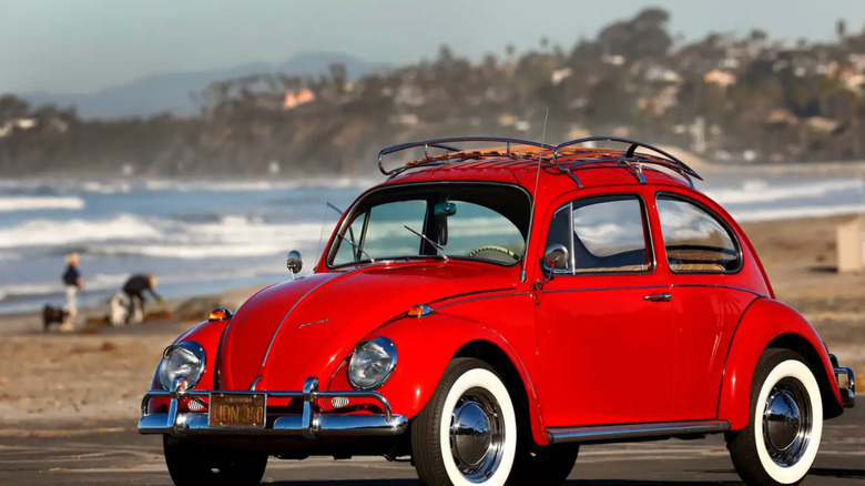 Red VW bug parked on a beach