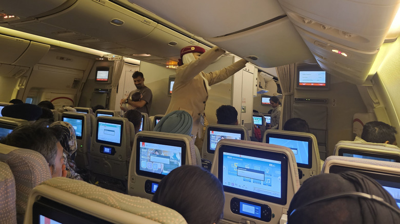 The Cabin of the Airbus A380 with people inside of it.