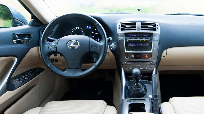 The front interior of a Lexus with a manual transmission.