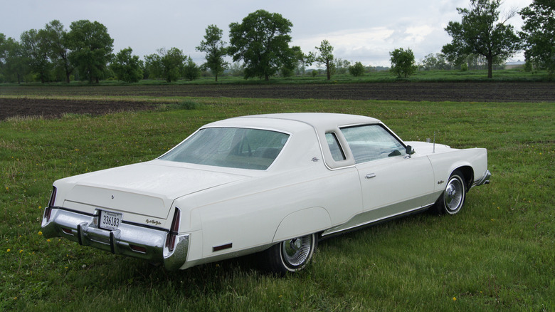 A white 1978 Chrysler New Yorker Brougham parked in a field