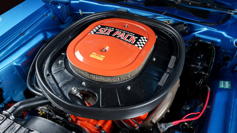 A Dodge 440 Magnum Six Pack engine in the engine bay of a blue car