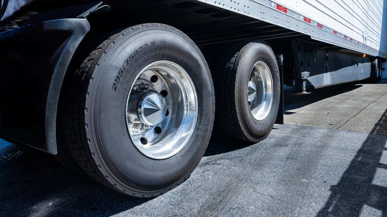 A truck's rear axle trailer tires with a clear focus on their lettering