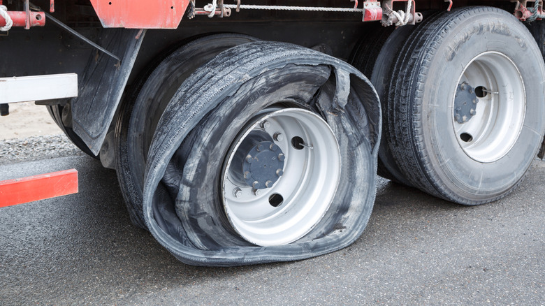 A close-up of a truck trailer tire blowout.