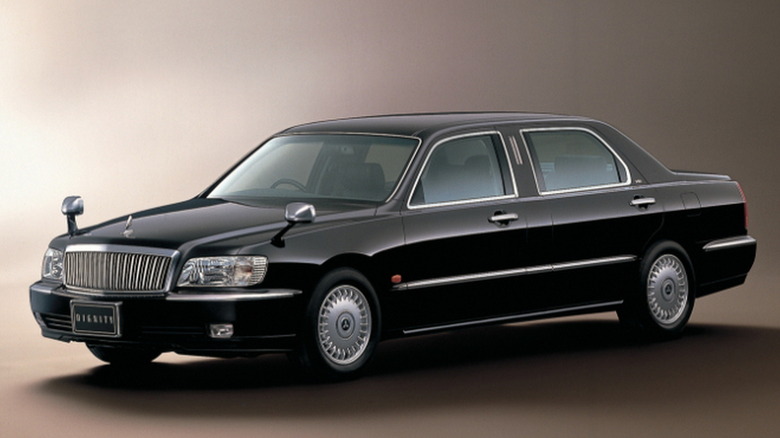 Studio shot of a black 2000 Mitsubishi Dignity sedan.
