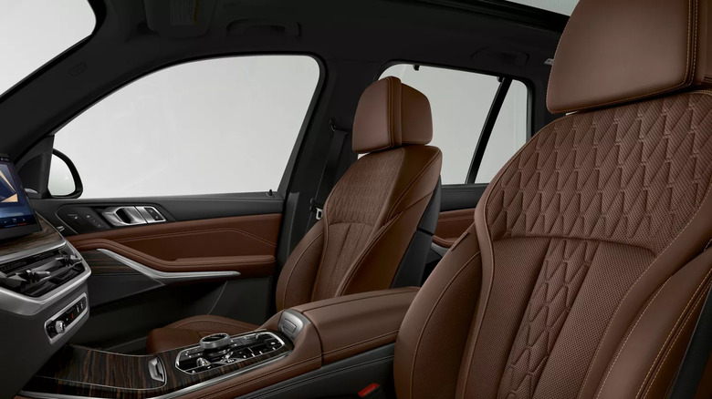 Interior of a 2025 BMW X5 with brown leather seats