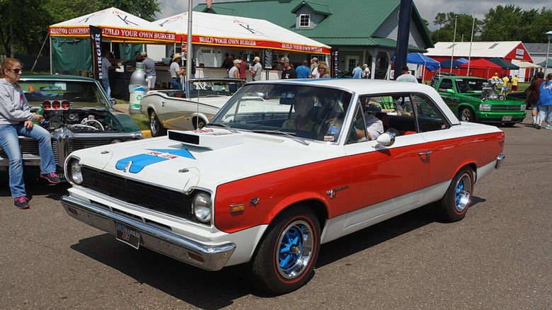 AMC SC/Rambler driving by at a car show