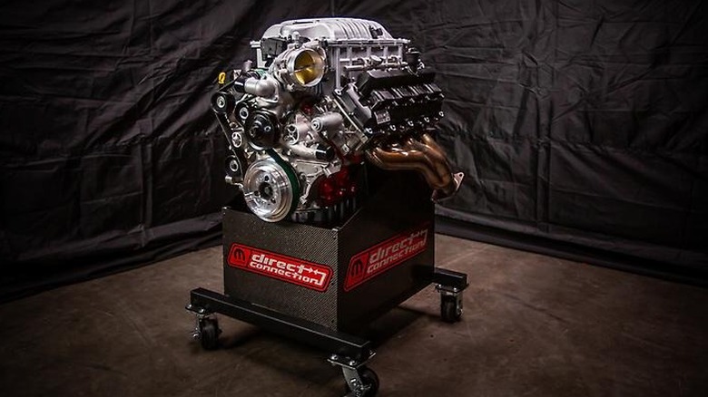 The 7.0-liter HEMI V8 Hellephant A170 engine on a display against a black backdrop.