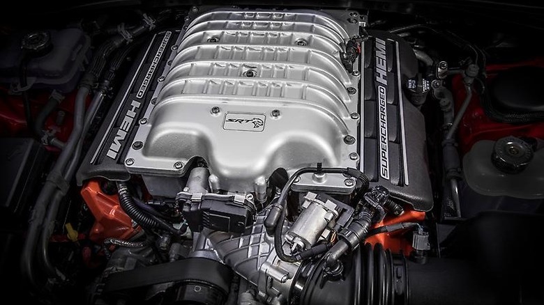 The Hellcat HEMI V8 engine pictured close up installed in a car.