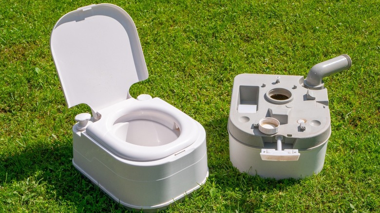 Upper tank and detached lower waste tank of a portable camping toilet.